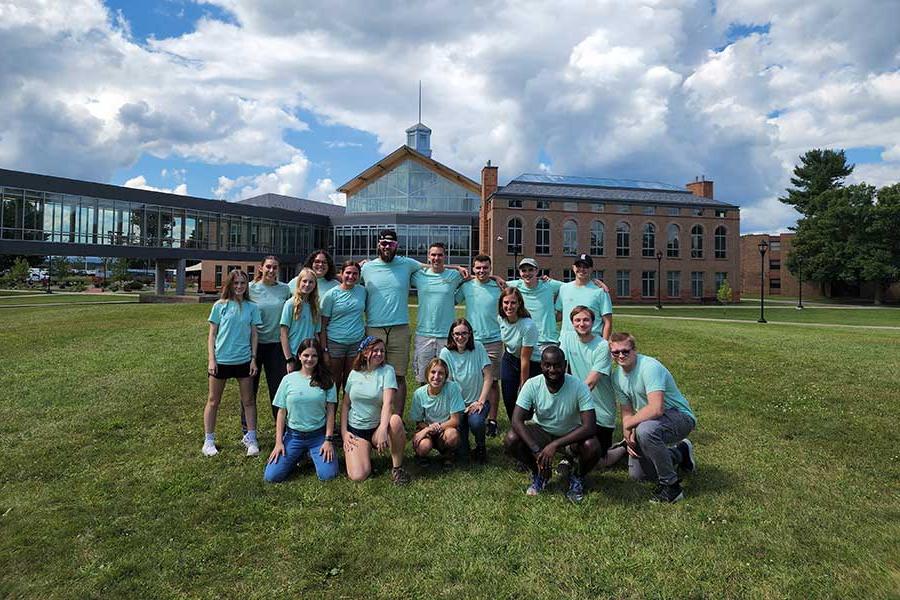 Group of students dressed in matching shirts on the Cheel lawn